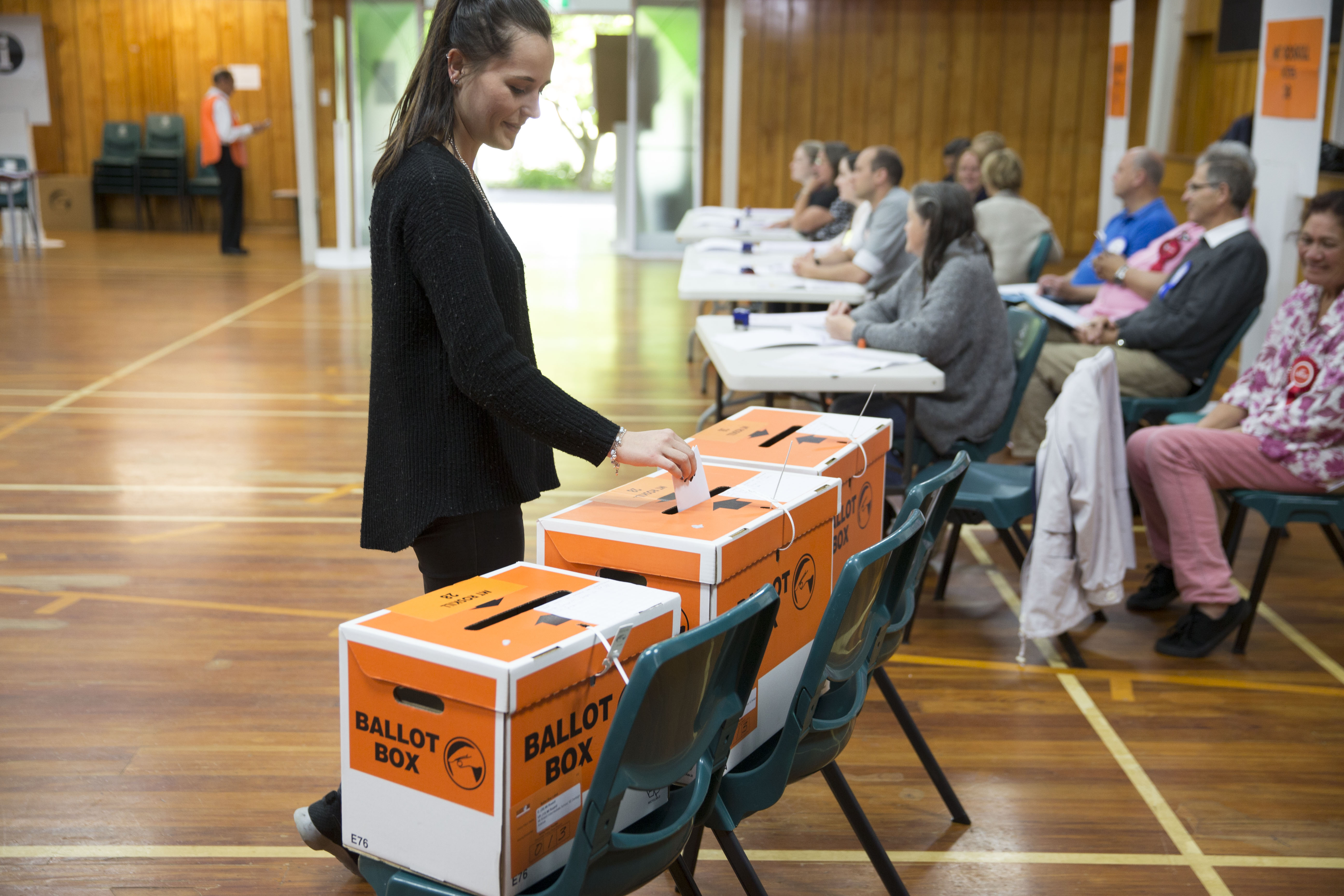 putting voting papers in the ballot box